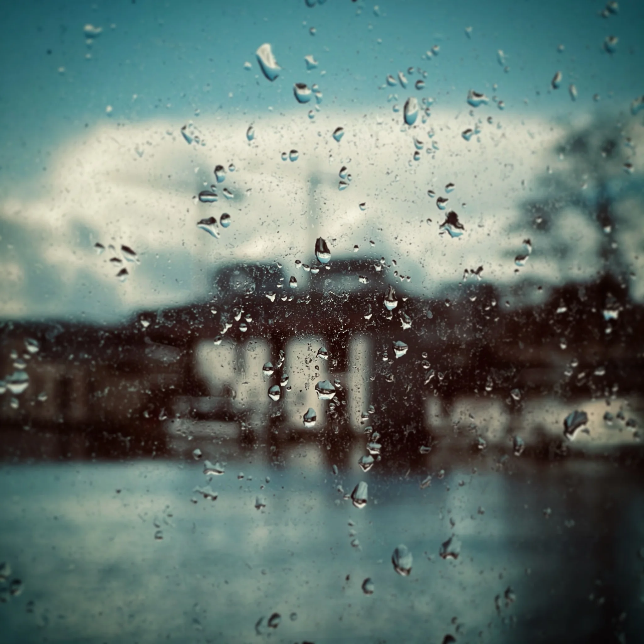 Rain on a window overlooking a building